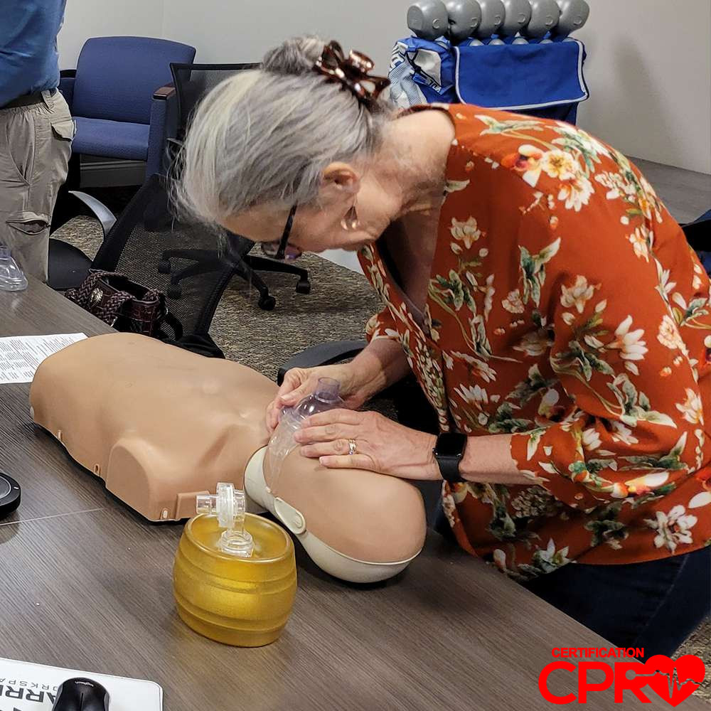 CPR training session with adult mannequin in Denver.